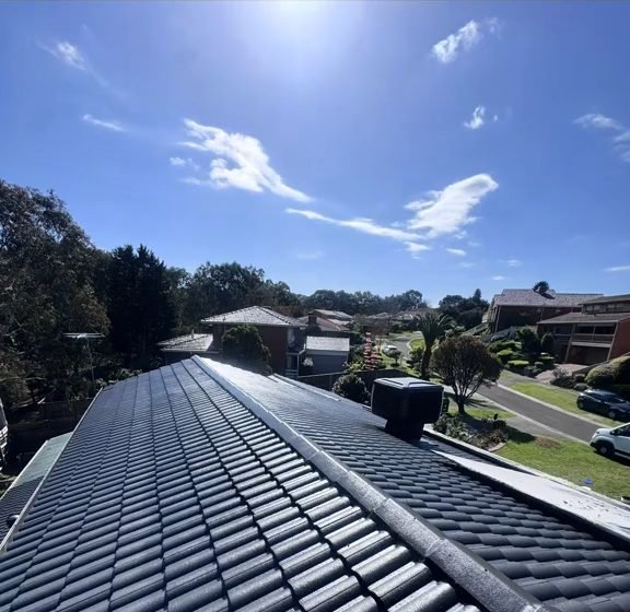 A tiled roof after restoration by ZX: an even dark coat, the ridge capping repointed
