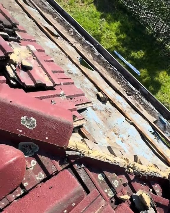 Failed bedding under lifted ridge tiles on another roof