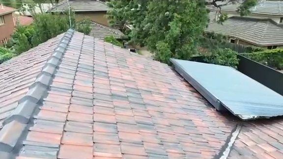 After: a terracotta tile roof seen from the hip