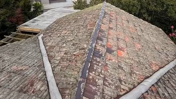 Before: a terracotta tile roof seen from the hip