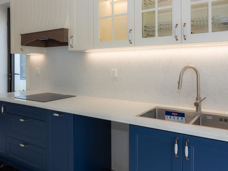Kitchen with navy painted lower cabinets and white upper cabinets