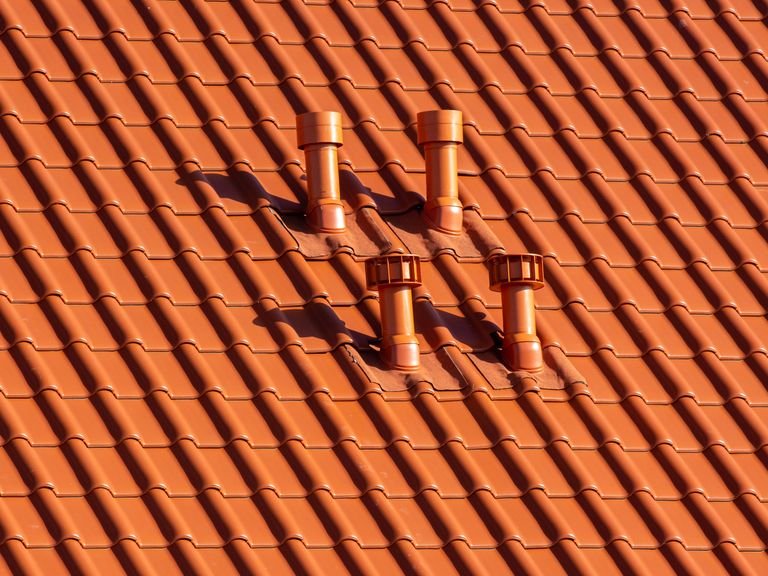 Restored terracotta roof tiles around four roof vents
